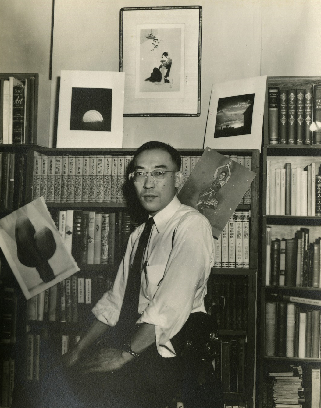 James Numata in his study decorated with his photographs, ca. 1951.