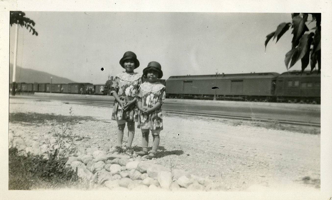 Yuki and Fumi Yamamoto in Whitefish, with train in background, ca. 1927.